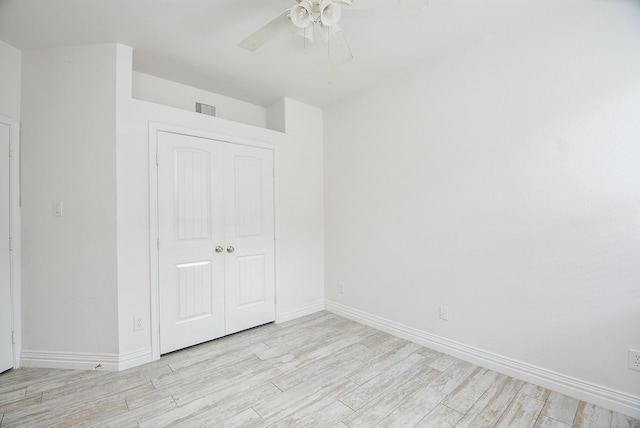 1049 Misty Clf, Dickinson, TX 77539 - unfurnished bedroom with baseboards, light wood-type flooring, a closet, and ceiling fan