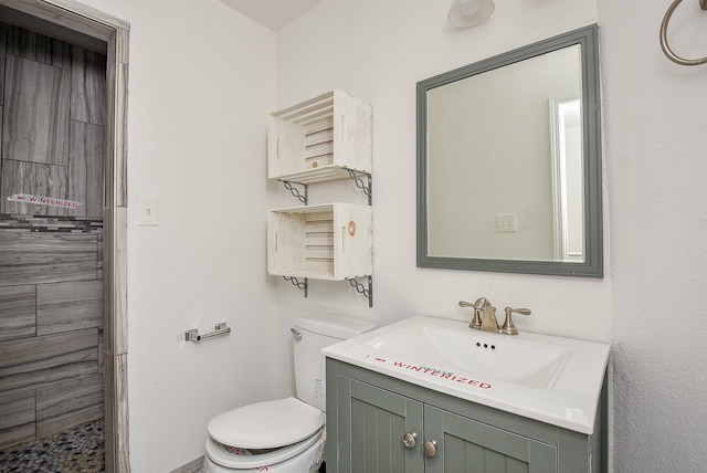 1049 Misty Clf, Dickinson, TX 77539 - bathroom featuring toilet, vanity, and a tile shower