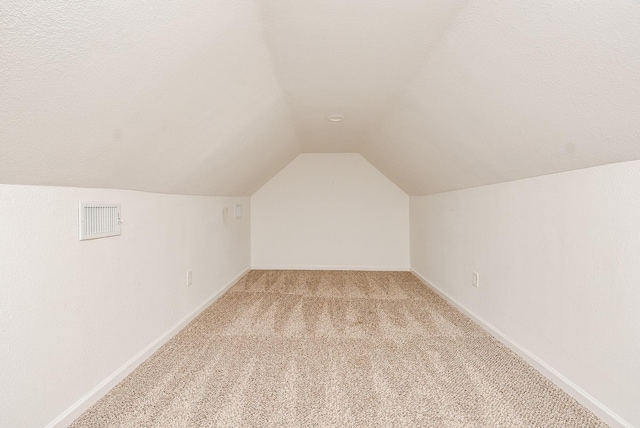 1049 Misty Clf, Dickinson, TX 77539 - additional living space featuring light colored carpet, lofted ceiling, and baseboards