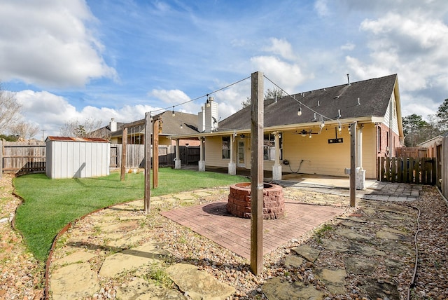 1049 Misty Clf, Dickinson, TX 77539 - rear view of house featuring an outdoor fire pit, a patio, a shed, an outbuilding, and ceiling fan