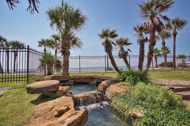 9520 Seawall Blvd Unit 235, Galveston, TX 77554 - view of yard featuring fence and a small pond
