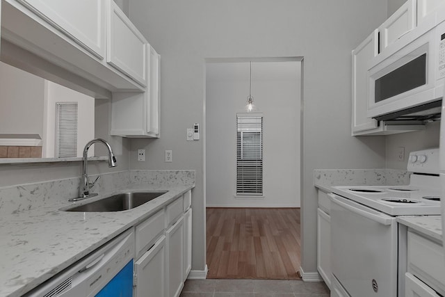 3500 Tangle Brush Dr Unit 217, The Woodlands, TX 77381 - kitchen featuring white appliances, a sink, white cabinets, and baseboards
