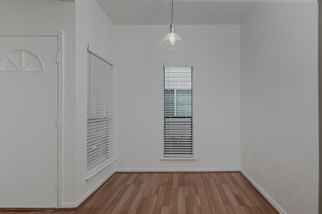 3500 Tangle Brush Dr Unit 217, The Woodlands, TX 77381 - unfurnished dining area featuring wood finished floors and baseboards