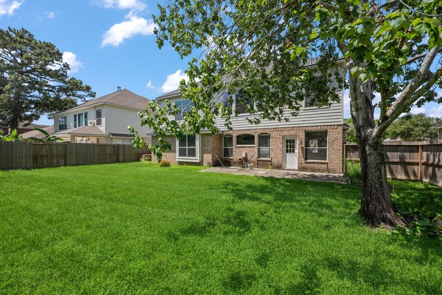 back of house with brick siding and a patio area