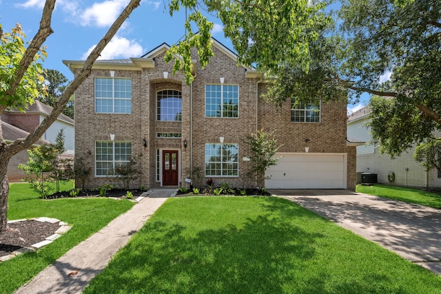 traditional-style house with brick siding, a garage, concrete driveway, and a front yard