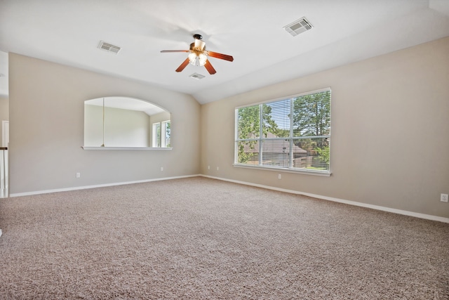 empty room with ceiling fan, carpet, baseboards, and vaulted ceiling