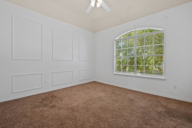 spare room with carpet floors, ceiling fan, and baseboards