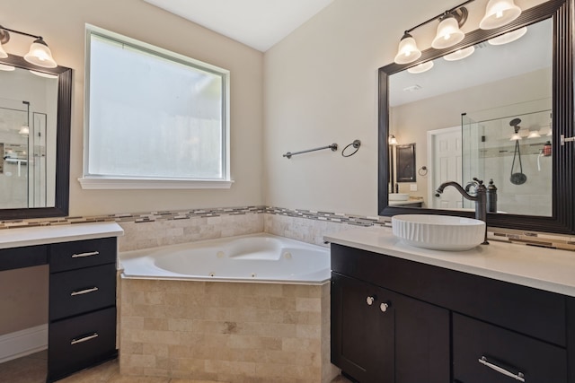 full bathroom with a stall shower, a jetted tub, and vanity