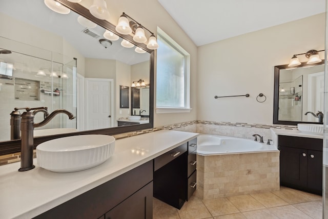 full bath with tile patterned flooring, a stall shower, a garden tub, and vanity