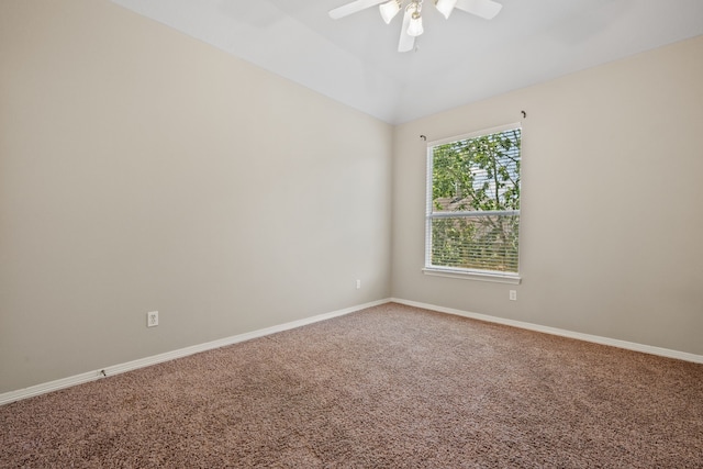 carpeted empty room with ceiling fan, baseboards, and lofted ceiling