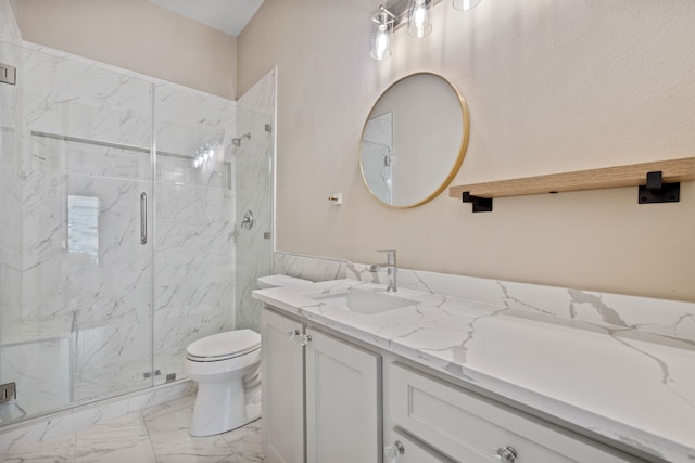 bathroom featuring marble look tiles, a marble finish shower, toilet, and vanity