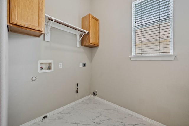 laundry area featuring hookup for a gas dryer, hookup for a washing machine, cabinet space, marble look tile flooring, and baseboards