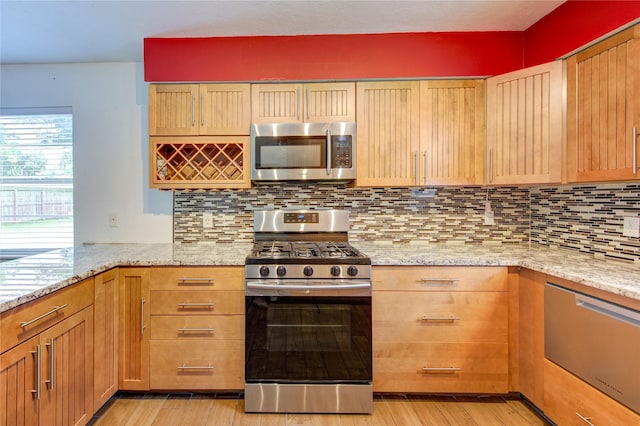 3711 Clover Meadows St, Pasadena, TX 77505 - kitchen with appliances with stainless steel finishes, light wood-type flooring, light stone counters, and tasteful backsplash