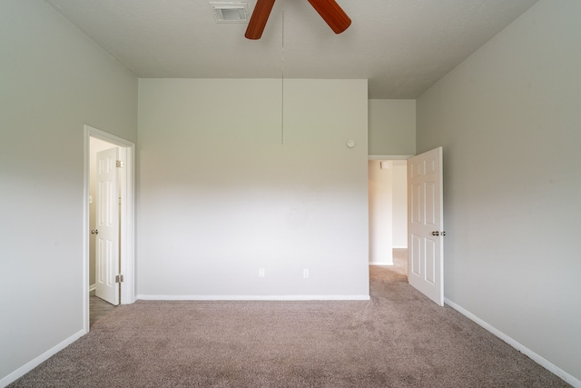 spare room featuring carpet floors, baseboards, and a ceiling fan