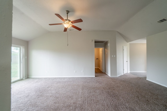 carpeted empty room featuring vaulted ceiling, ceiling fan, and baseboards