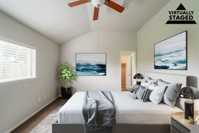 carpeted bedroom featuring vaulted ceiling, baseboards, and ceiling fan