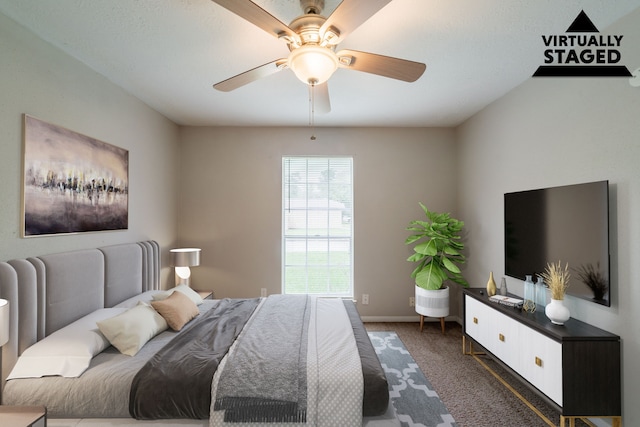 bedroom featuring dark carpet, ceiling fan, and baseboards