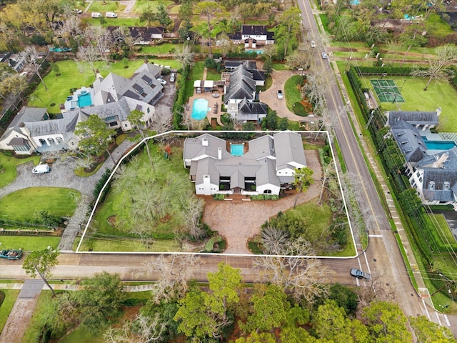 aerial view of property and surrounding area with a pool, property parcel outlined, and nearby suburban area