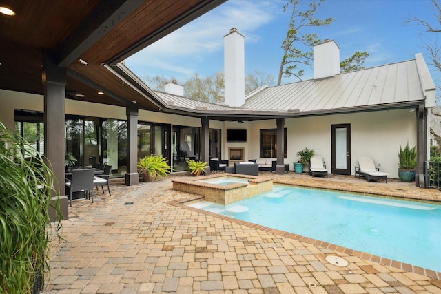 view of swimming pool with a patio area, a pool with connected hot tub, and an outdoor hangout area