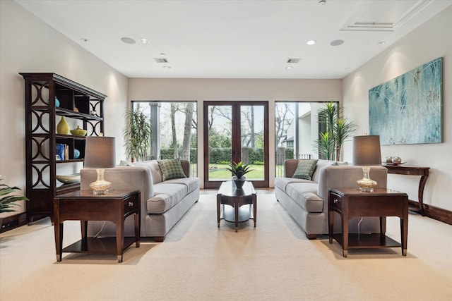 living area featuring healthy amount of natural light, carpet floors, and baseboards