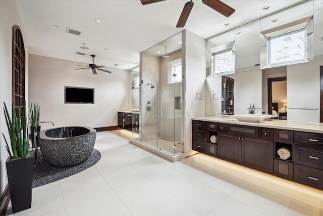 full bath with ceiling fan, vanity, a stall shower, a freestanding tub, and recessed lighting