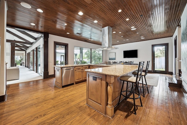 kitchen featuring dishwasher, island exhaust hood, light wood-style flooring, a large island with sink, and wooden ceiling