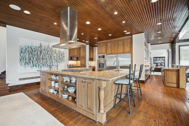 kitchen featuring built in appliances, island exhaust hood, baseboards, dark wood-style flooring, and recessed lighting