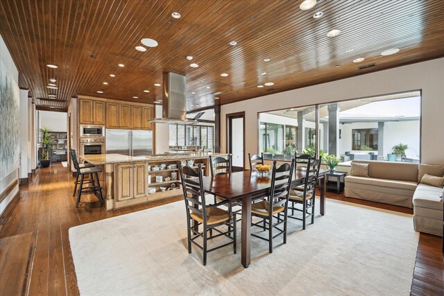 dining room featuring recessed lighting, light wood-style flooring, and wood ceiling