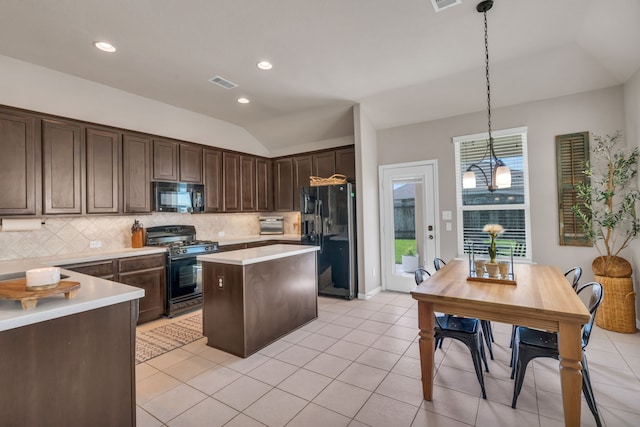 9962 Ash Creek Ct, Brookshire, TX 77423 - kitchen with black appliances, backsplash, dark brown cabinets, a center island, and light countertops