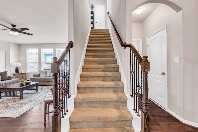 9962 Ash Creek Ct, Brookshire, TX 77423 - stairs with ceiling fan, wood-type flooring, arched walkways, and baseboards