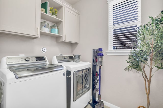 9962 Ash Creek Ct, Brookshire, TX 77423 - laundry room featuring separate washer and dryer, cabinet space, and baseboards