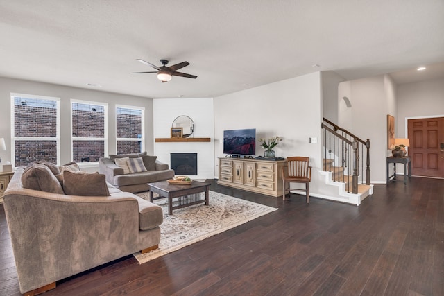 9962 Ash Creek Ct, Brookshire, TX 77423 - living room with ceiling fan, a glass covered fireplace, wood finished floors, stairway, and recessed lighting