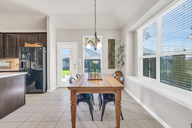 9962 Ash Creek Ct, Brookshire, TX 77423 - dining space with light tile patterned floors, plenty of natural light, a chandelier, and lofted ceiling