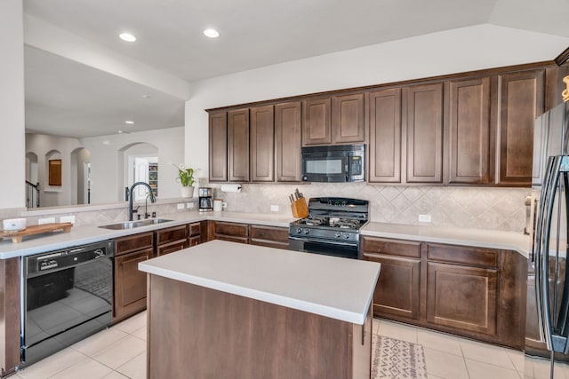 9962 Ash Creek Ct, Brookshire, TX 77423 - kitchen with black appliances, a sink, arched walkways, light tile patterned floors, and recessed lighting