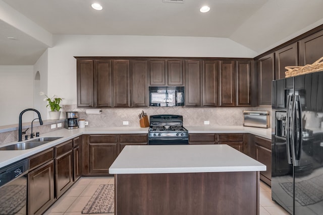 9962 Ash Creek Ct, Brookshire, TX 77423 - kitchen with black appliances, a sink, light tile patterned floors, dark brown cabinets, and tasteful backsplash