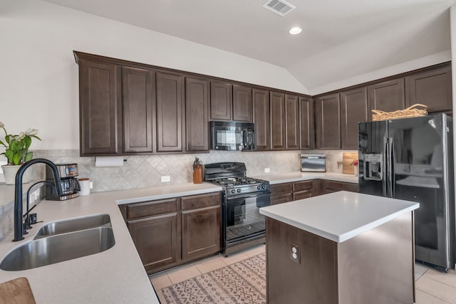 9962 Ash Creek Ct, Brookshire, TX 77423 - kitchen featuring black appliances, a sink, dark brown cabinets, light tile patterned floors, and vaulted ceiling