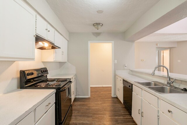 5935 Caruso Forest Dr, Houston, TX 77088 - kitchen with black appliances, under cabinet range hood, a sink, dark wood-style flooring, and white cabinets