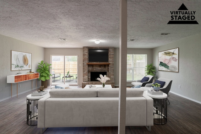 5935 Caruso Forest Dr, Houston, TX 77088 - living room featuring wood finished floors, a fireplace, baseboards, healthy amount of natural light, and a textured ceiling