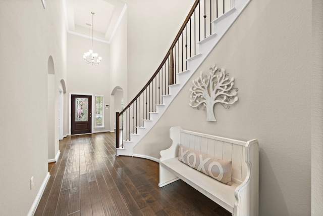 27916 Seger Bend Trl, Spring, TX 77386 - foyer entrance with arched walkways, dark wood-style floors, baseboards, stairway, and a high ceiling
