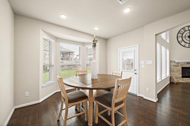 27916 Seger Bend Trl, Spring, TX 77386 - dining room featuring baseboards, a fireplace, plenty of natural light, dark wood-style floors, and recessed lighting