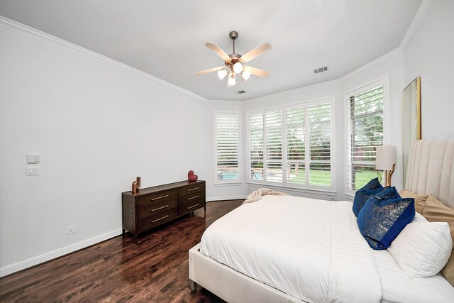 bedroom with crown molding, dark wood-type flooring, baseboards, and a ceiling fan