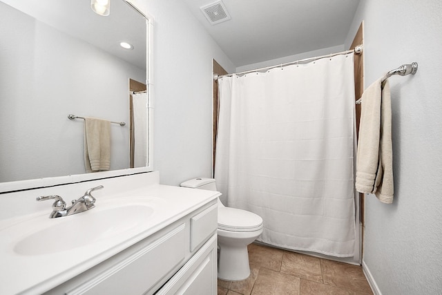 bathroom featuring vanity, toilet, a shower with curtain, and stone finish flooring