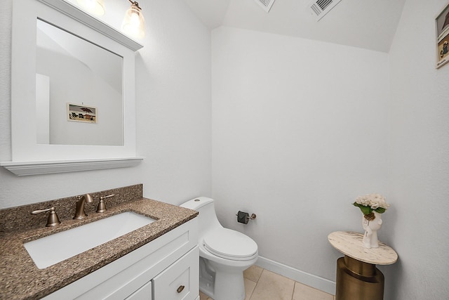 bathroom featuring tile patterned flooring, toilet, vanity, and baseboards