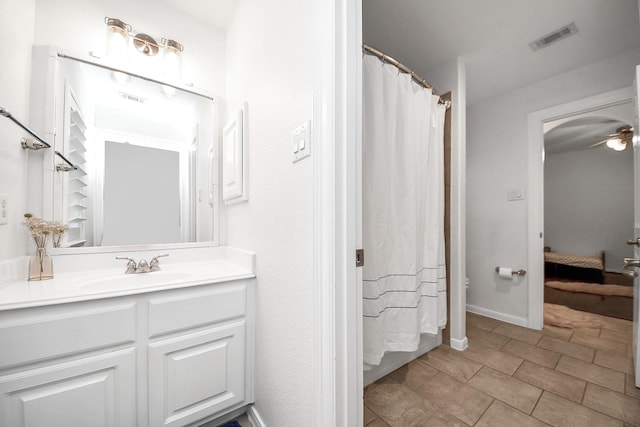 full bath with ceiling fan, vanity, baseboards, and tile patterned flooring