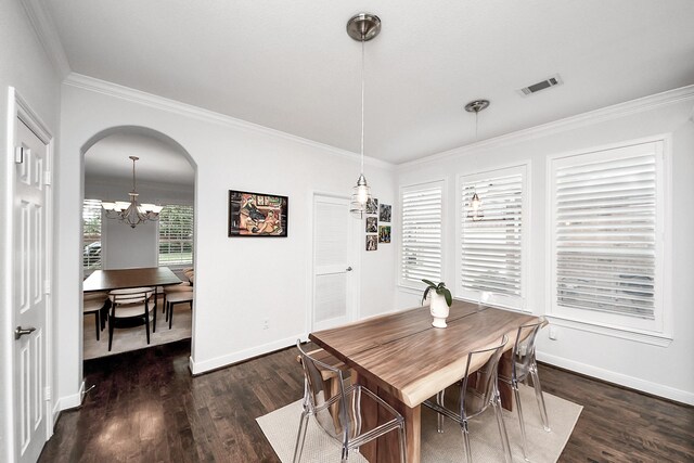 dining space featuring a chandelier, arched walkways, wood finished floors, ornamental molding, and baseboards