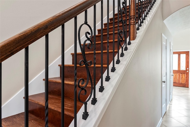 stairway with tile patterned floors