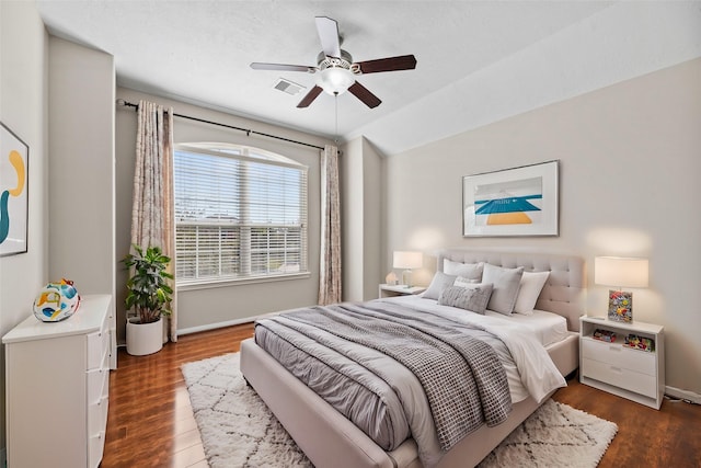 bedroom featuring baseboards, dark wood-style floors, ceiling fan, and lofted ceiling