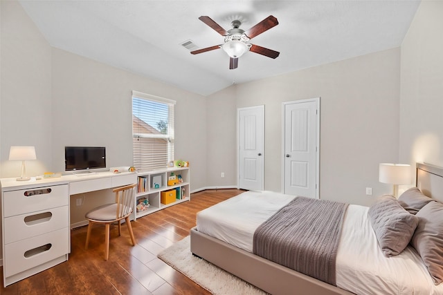 bedroom with dark wood-style floors, an office area, a ceiling fan, and lofted ceiling