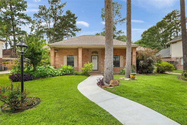 12915 Lake Mist Dr, Cypress, TX 77429 - view of front facade featuring brick siding, a front lawn, roof with shingles, and central air condition unit