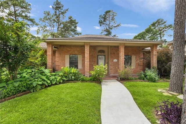 12915 Lake Mist Dr, Cypress, TX 77429 - ranch-style house with brick siding, a front lawn, and covered porch